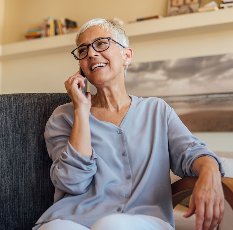 mature woman talking on phone giving out her patient information