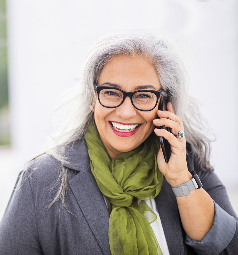 mature woman on the phone to contact Northwest Neurosurgical Associates in Portland